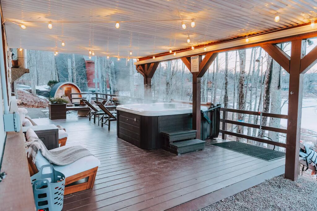 Snowy deck and hot tub at the retreat lodging
