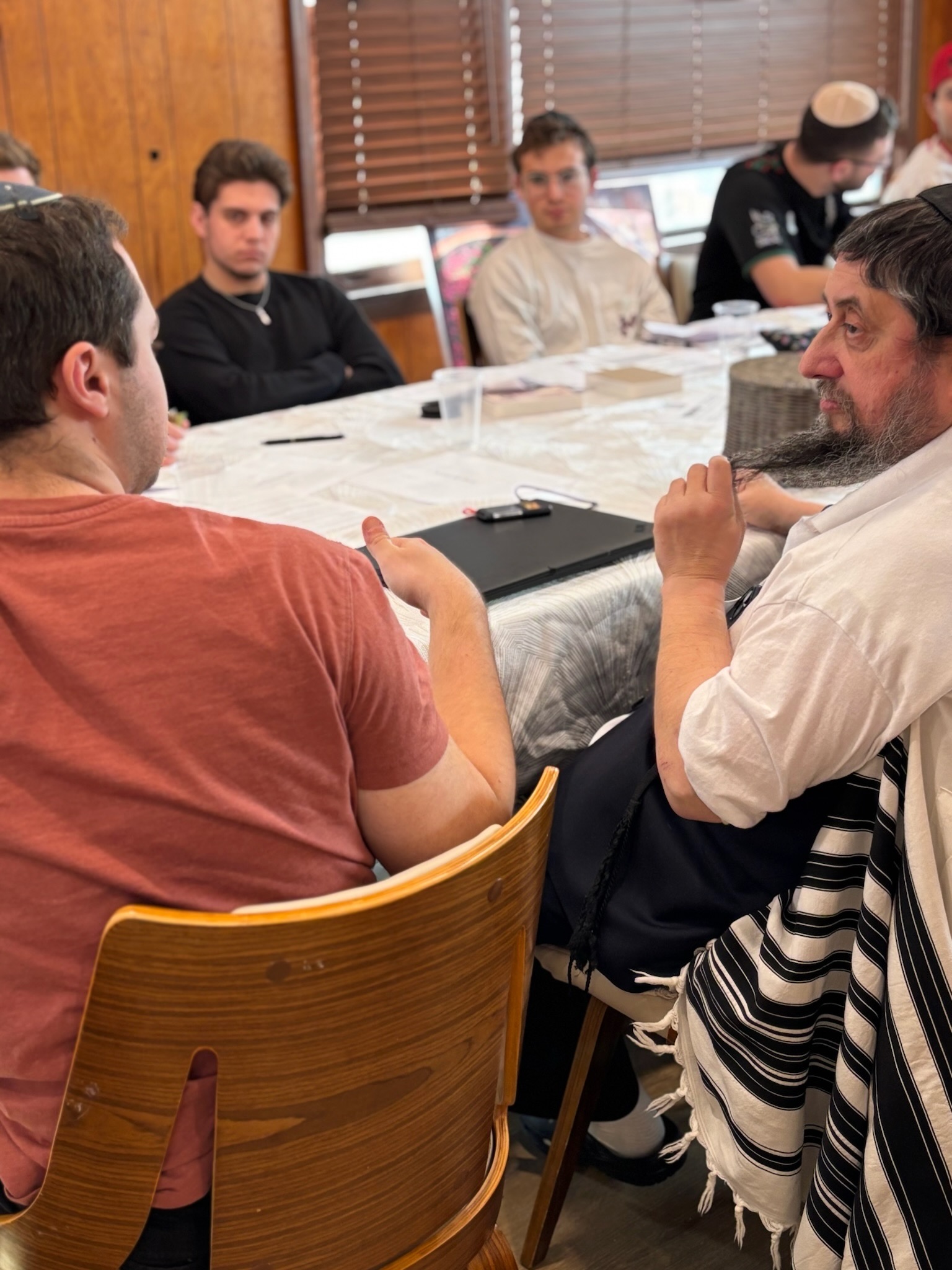 Students learning together with a rabbi